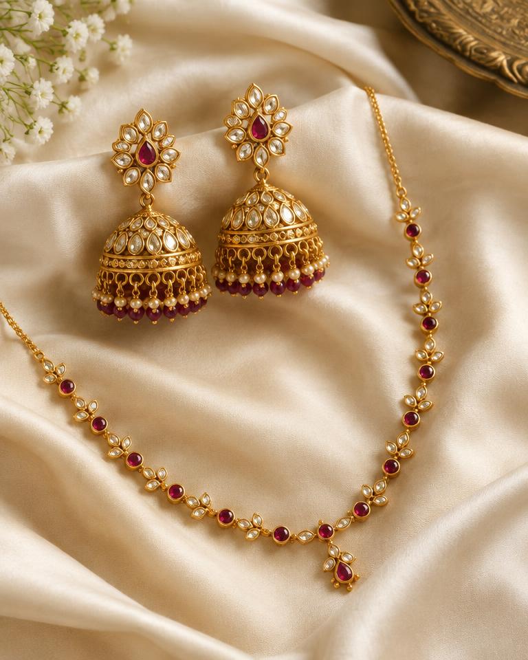 Gold kundan jhumkas and necklace on ivory silk